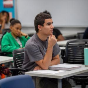 Student sitting at desk focusing on the professor