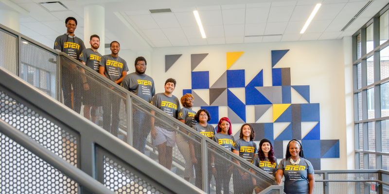 Students posing for photo on the stairs