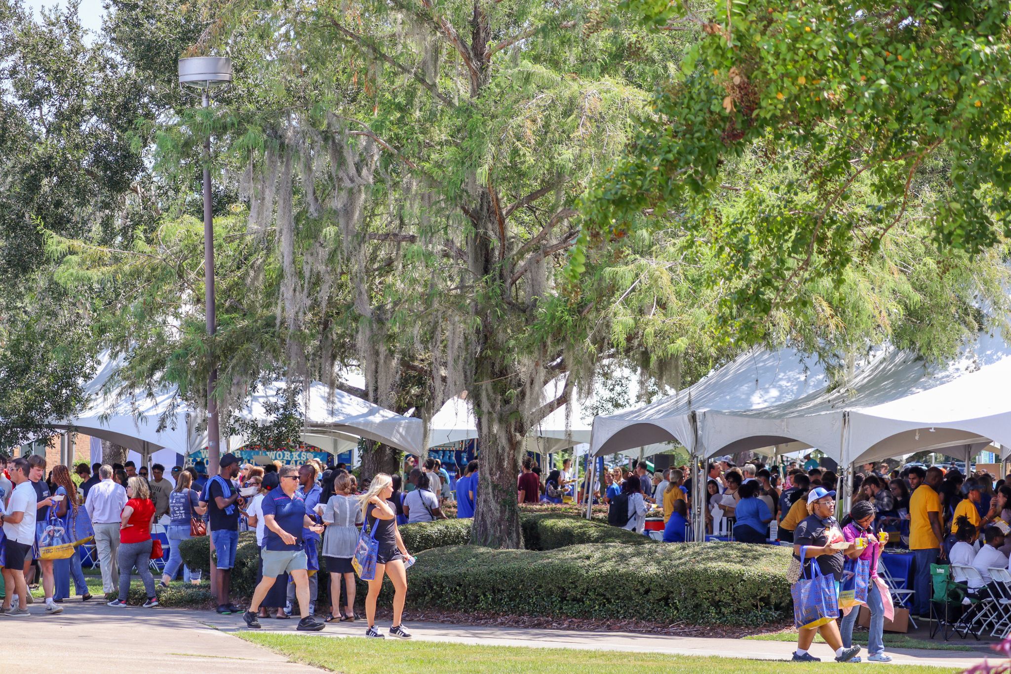 Crowd at Convocation walking between tents.