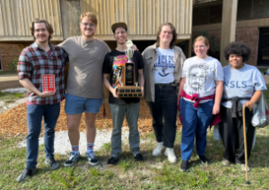 Brain bowl team of 6 students posing with an award