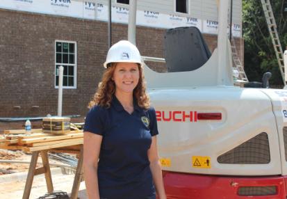 Commissioner Doizer standing next to equipment 