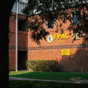 A brick building front with the letters 