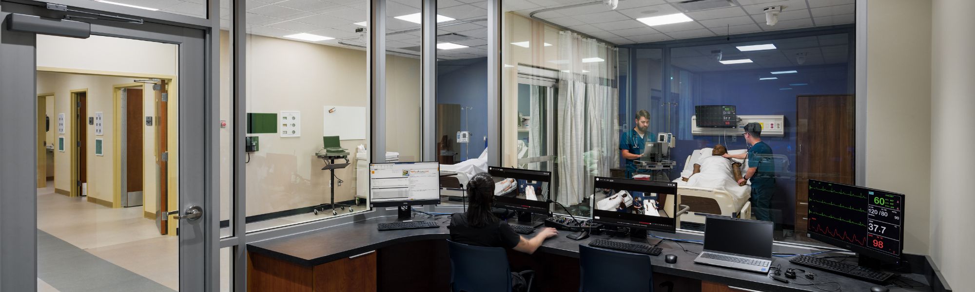 Screens and command station of a nursing class simulation.