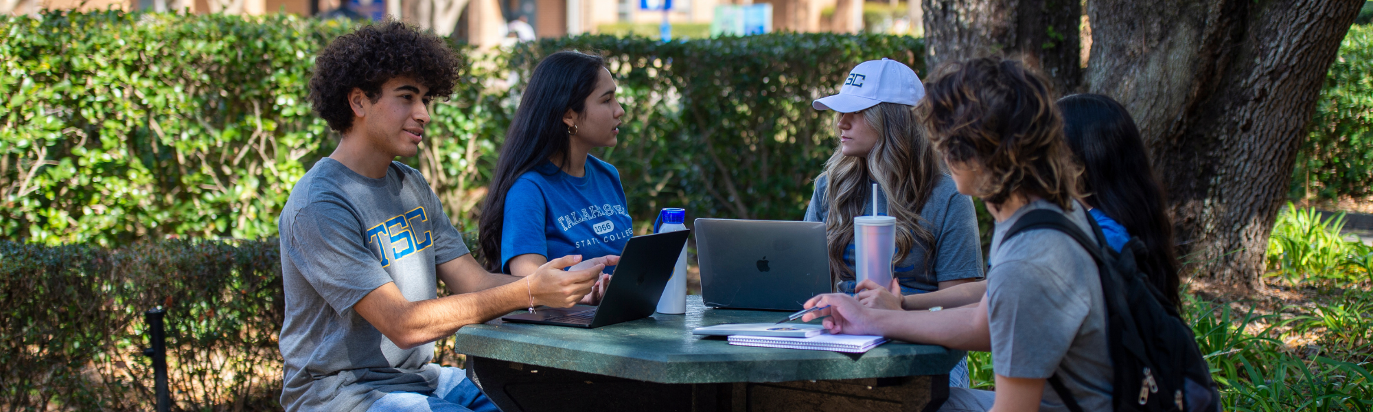 Five students having a conversion while doing homework